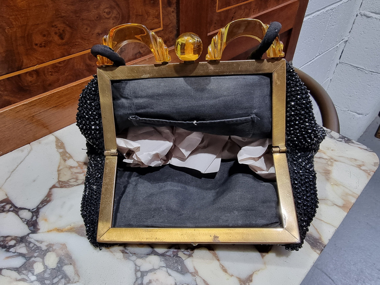 Black fabric vintage style evening bag with amber coloured clasp. In good original condition.