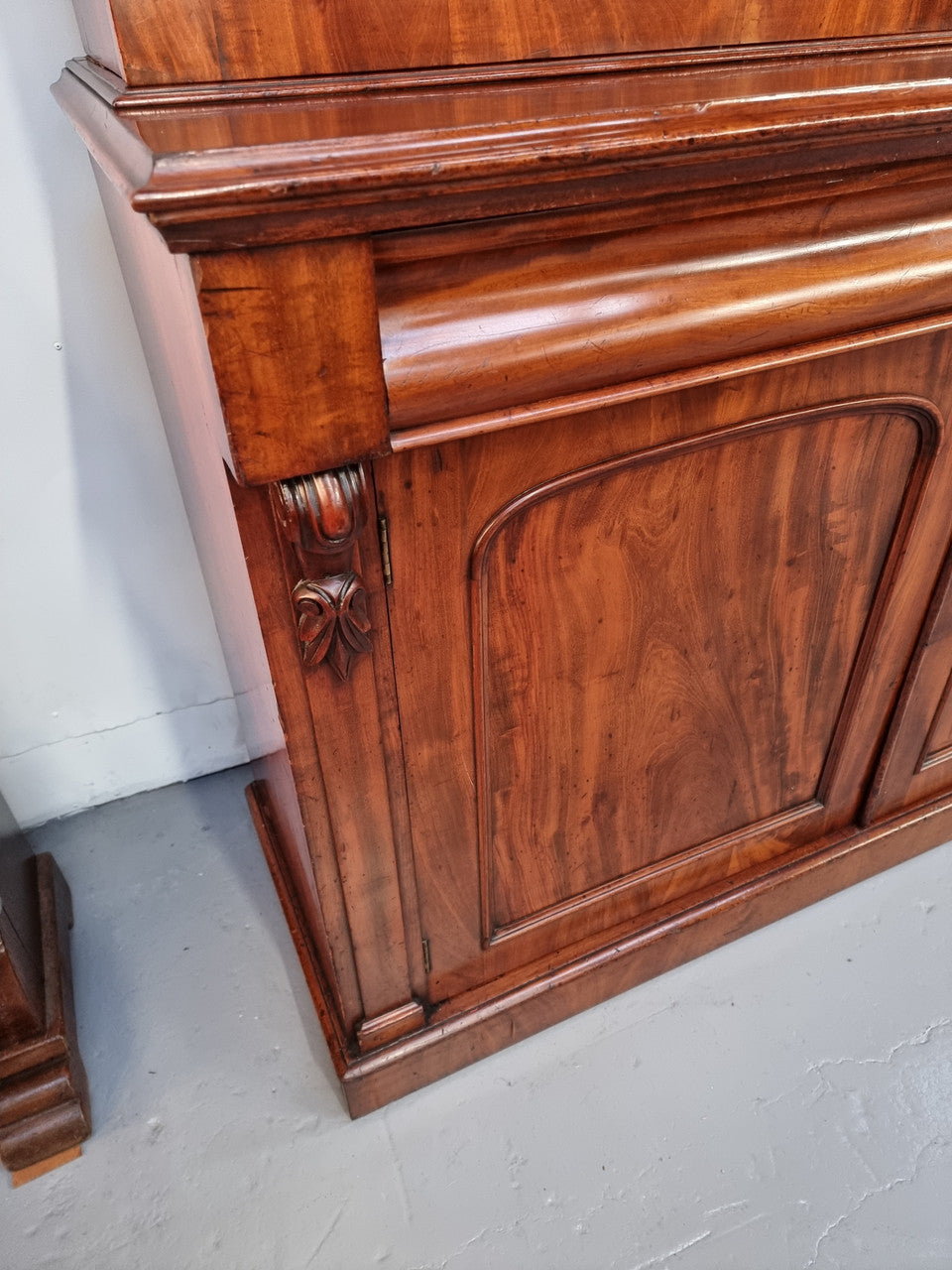 Early Victorian large flame Mahogany bookcase. Plenty of storage room with two doors and two drawers. In very good original detailed condition.