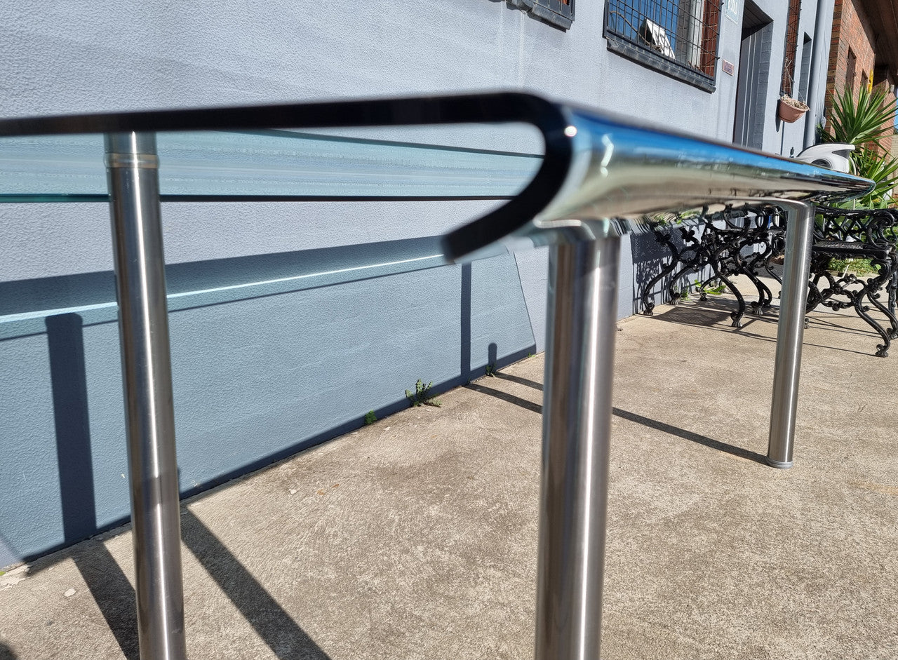 Striking and distinctive Vintage FIAM Italia Designer curved edge glass desk. FIAM was founded in 1973 by Vittorio Livio and has become synonymous with glass culture in Italy and the World. FIAM is still manufacturing today, in collaboration with various Designers, and has won numerous awards and is represented in various international museums. 
Condition: Evidence of use with minor scratches to the surface and a small chip that has been repaired. Overall, in very good condition with one repaired chip to t