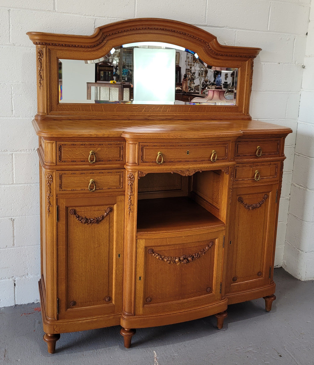 Beautiful French Oak Louis XVI Style nicely carved sideboard with a lovely parquetry top and mirror. It has five drawers and three cupboards for all your storage needs. In good original detailed condition.