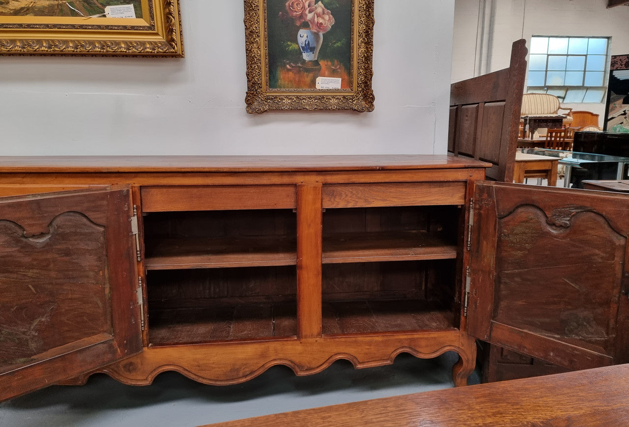 Early 19th Century Louis XV style Fruitwood three door sideboard. It has three hidden internal drawers and one of them has green valet and small sections for cutlery. It is in good restored condition.