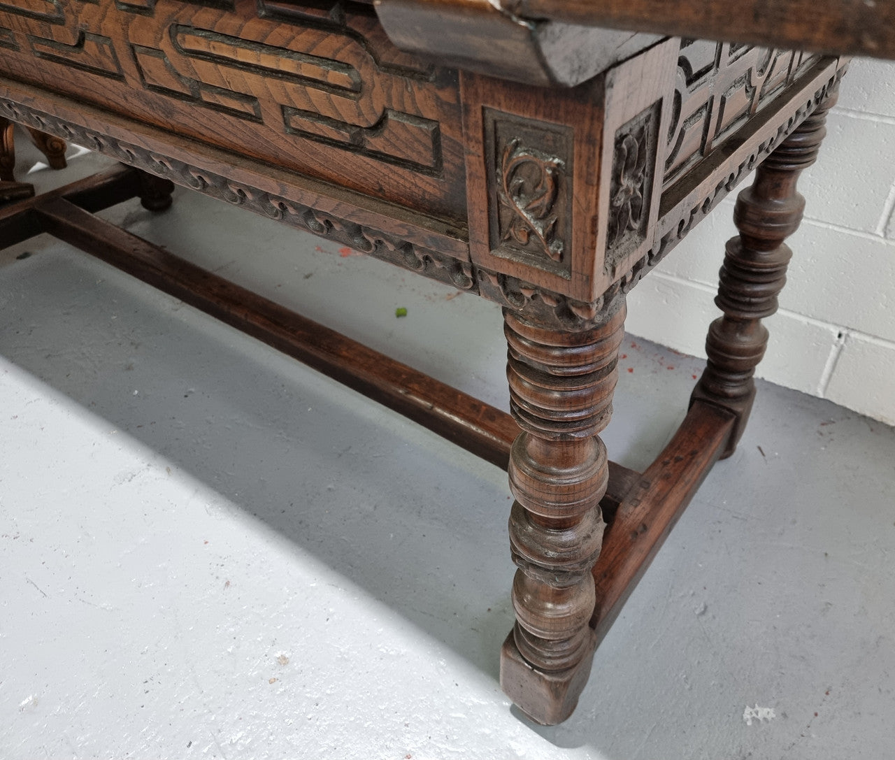 Rare and Charming 17th Century Spanish Walnut serving / side table. It has an incredible one piece walnut top with amazing character and colour. The base displays the original patina aswell as three drawers with carving and remnants of original locks. Superbly turned legs terminating on a stretcher base. Could be used as a large entrance console table, a side table or in a dining area as a serving table. In good original detailed condition especially considering its age.