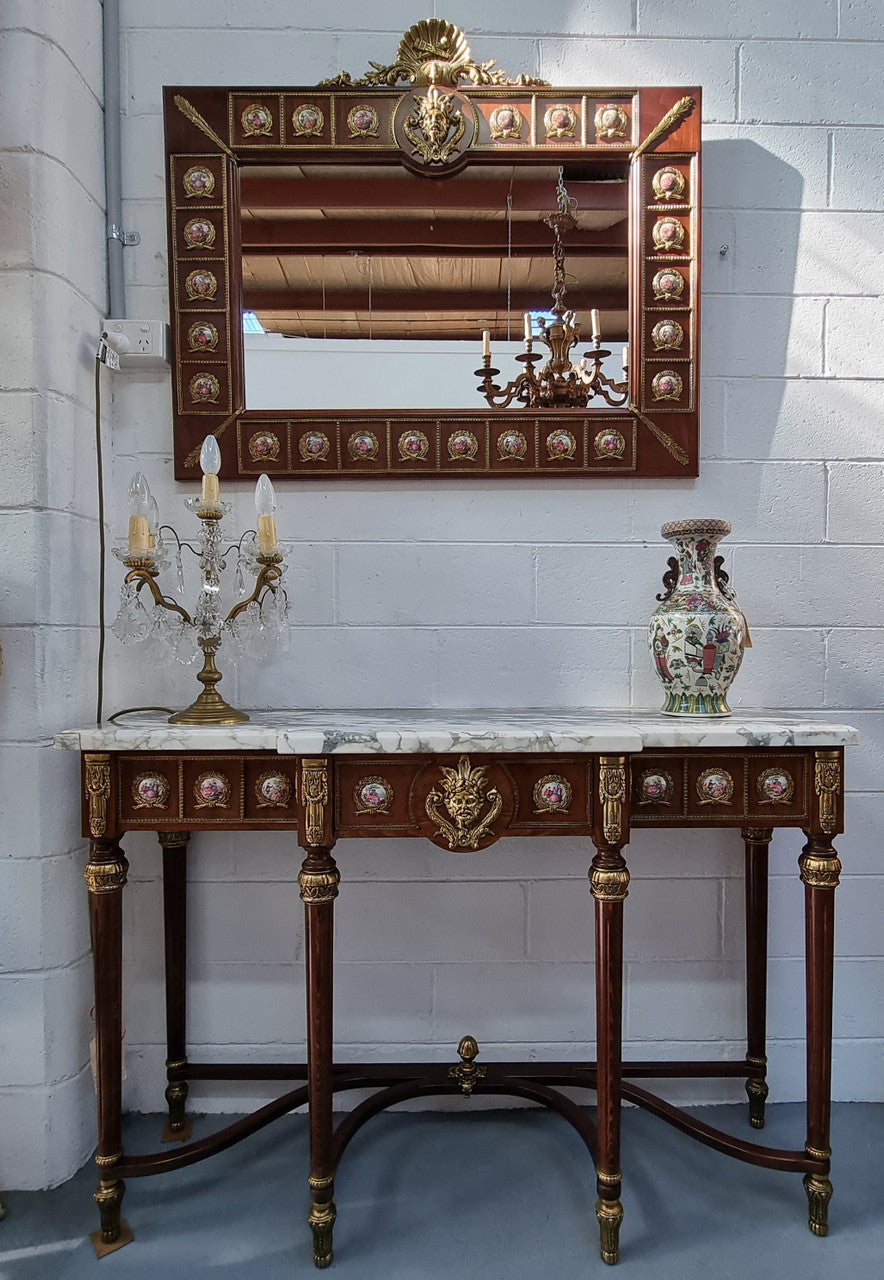Vintage Mahogany marble top console table with matching mirror. Both with inset limoge panels surrounded by gilt brass. Highly decorative and in good original detailed condition. Circa 1950.