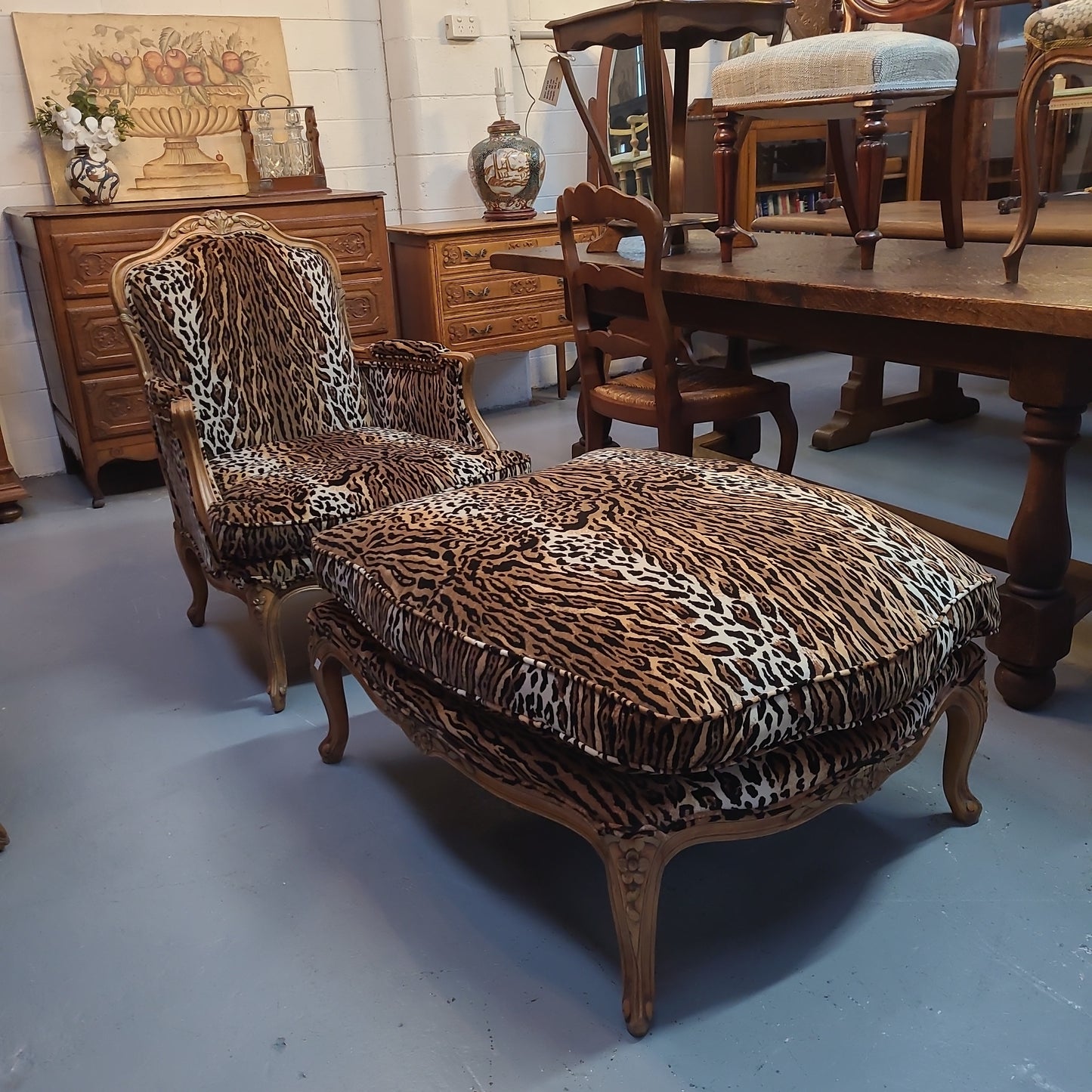 A French Louis XV style Armchair With Leopard Print Upholstery With Matched Footstool