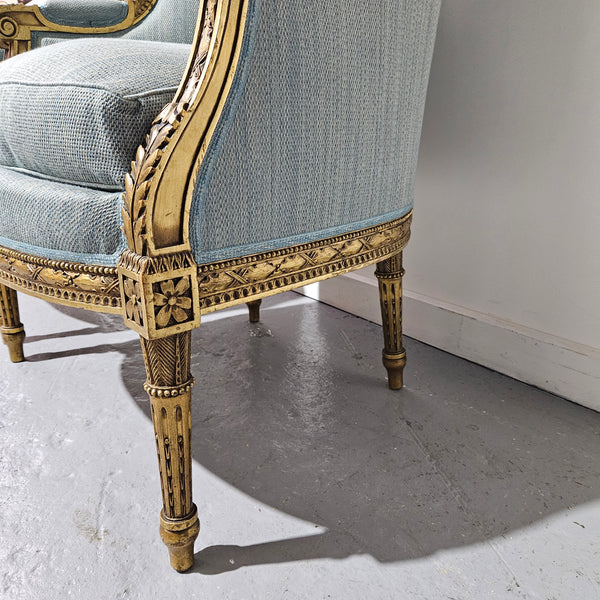 Lovely pair of Louis 16th style gilt & upholstered wingback bergeres with two comfortable cushions. These chairs are in good original condition. Please view photos as they form part of the description.
