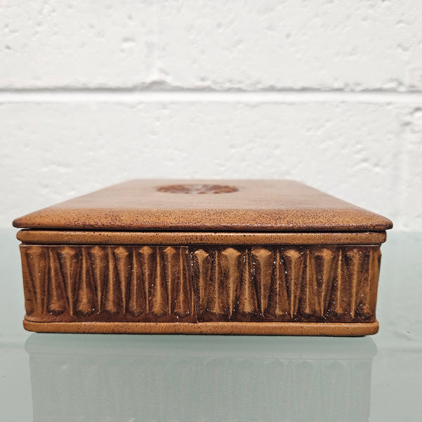 Interesting embossed leather and wood attached lid trinket box. In good original condition. Please see photos as they form part of the description.