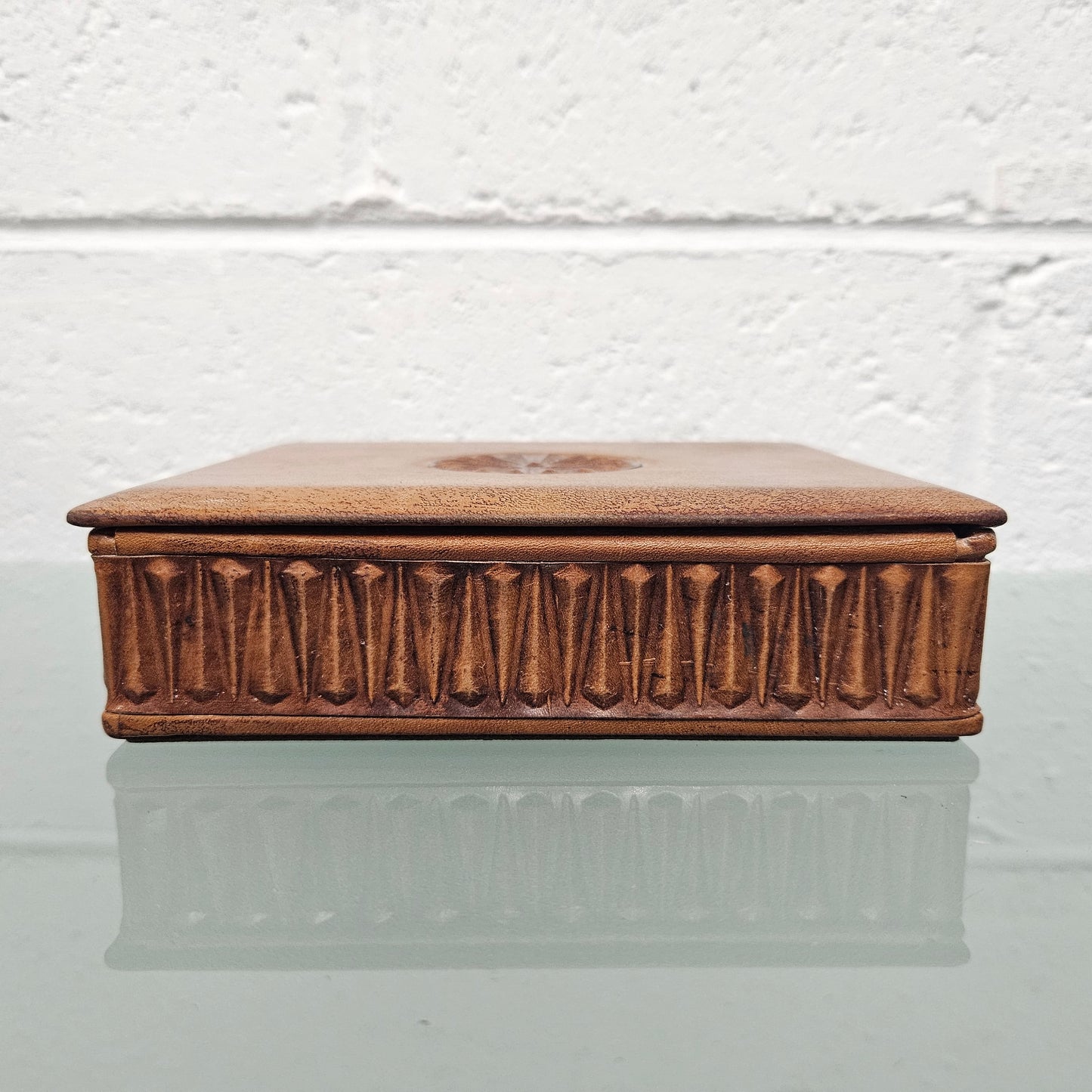 Interesting embossed leather and wood attached lid trinket box. In good original condition. Please see photos as they form part of the description.