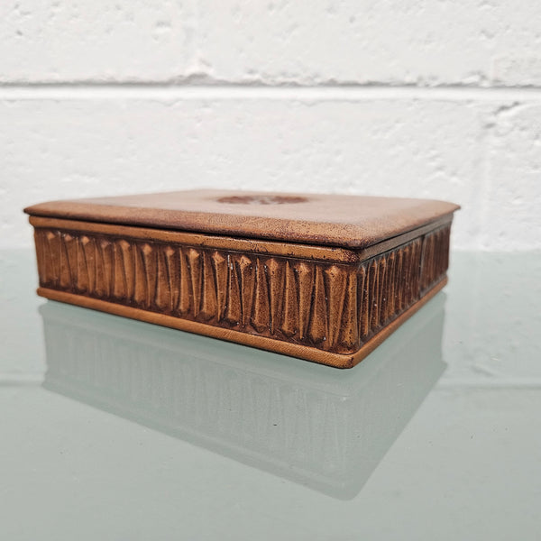 Interesting embossed leather and wood attached lid trinket box. In good original condition. Please see photos as they form part of the description.