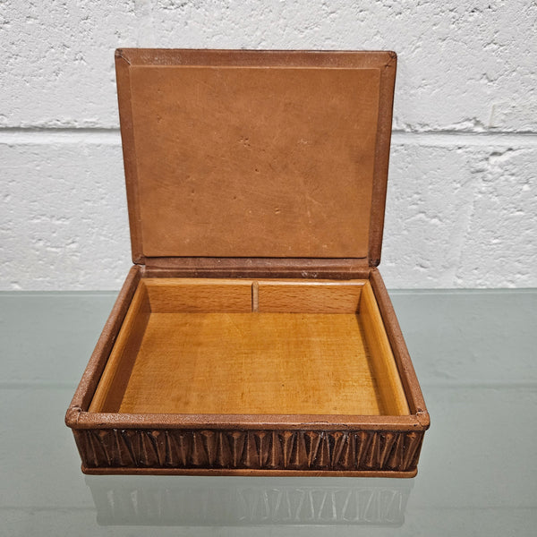 Interesting embossed leather and wood attached lid trinket box. In good original condition. Please see photos as they form part of the description.