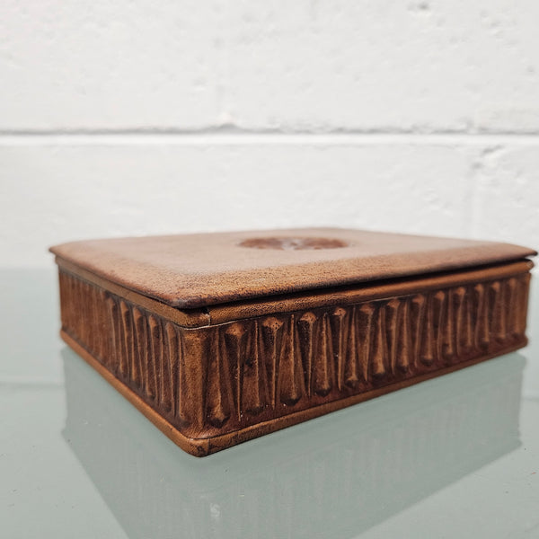 Interesting embossed leather and wood attached lid trinket box. In good original condition. Please see photos as they form part of the description.