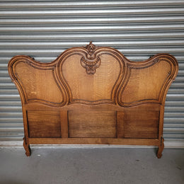 Beautifully carved French Oak Louis XV style queen size bed. It comes with beautiful carved side rails and custom made slats ready for your mattress. Sourced from France it is in good original detailed condition.
