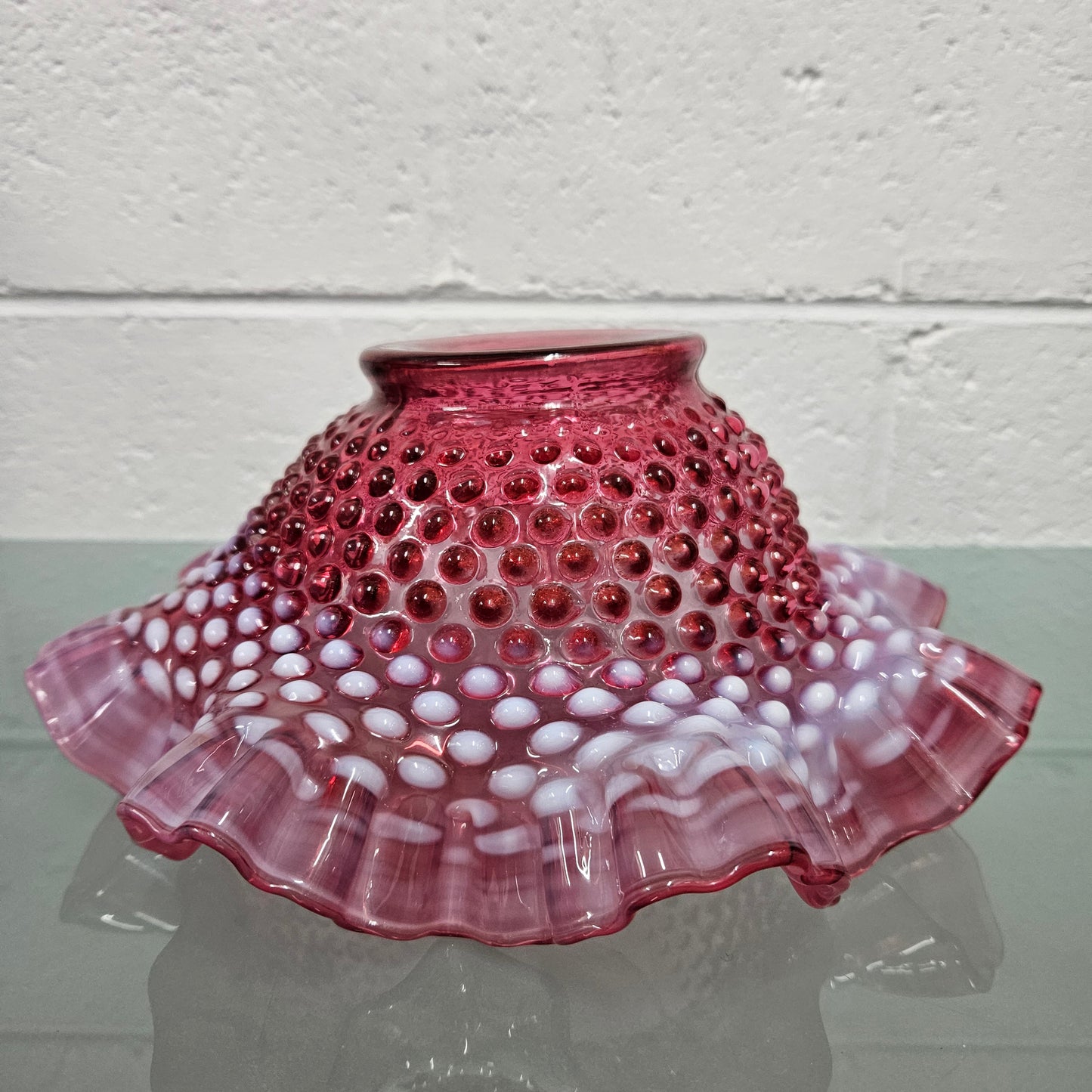 Vintage Large Fenton Cranberry glass bowl with opalescent trim.  In good condition.  Please see photos as  they form part of the description.