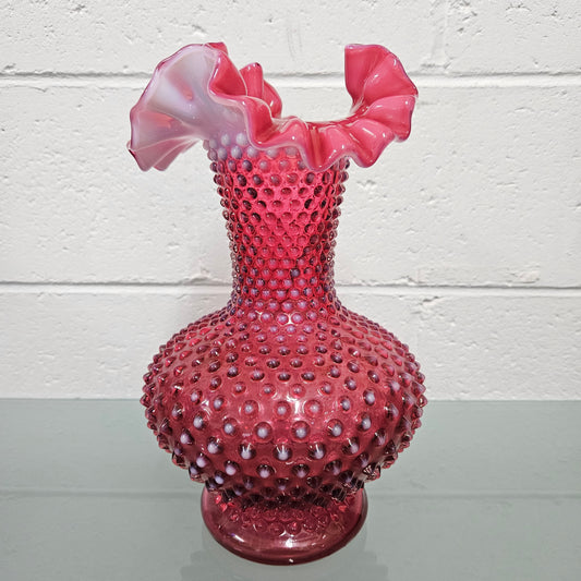 Large vintage Fenton cranberry glass vase with opalescent trim and frilled top. In good condition.  Please see photos as they form part of the description.