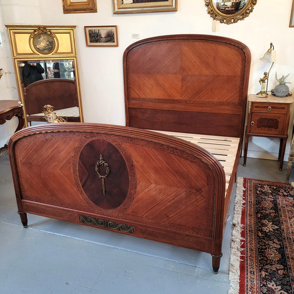 This elegant French Art Deco Walnut & Burr Walnut queen-size bed showcases stunning bronze mounts and impeccable craftsmanship. Its custom-made slats ensure a comfortable and supportive rest, while the ease of assembly and disassembly adds to its practicality. Sourced directly from France, it has been detailed and is in good condition.