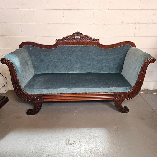 Stylish mahogany Empire Style upholstered 2.5 seater settee.&nbsp; Lovely carved back and sides.&nbsp; Circa: 1830's. In good condition commensurate with age.