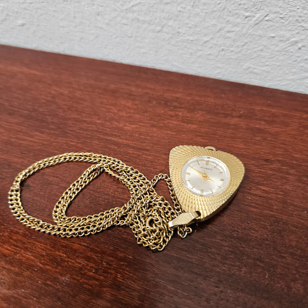 Vintage Gold coloured "Mundo" Pendant Watch. Triangle Shape with round watch face and in working condition.&nbsp;