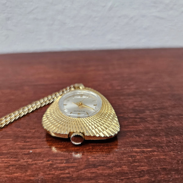 Vintage Gold coloured "Mundo" Pendant Watch. Triangle Shape with round watch face and in working condition.