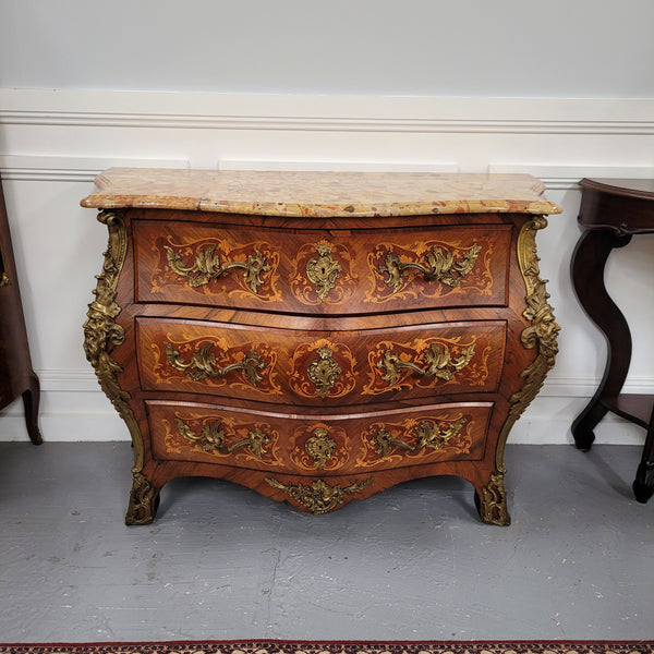 This exceptional 19th Century French Louis XV Kingwood and Rosewood marquetry inlaid marble top bombe shaped commode is an exceptional example of fine craftsmanship. Featuring exquisite decorative marquetry inlay throughout and elegant bronze mounts. It has been sourced from France and is in good original detailed condition. 