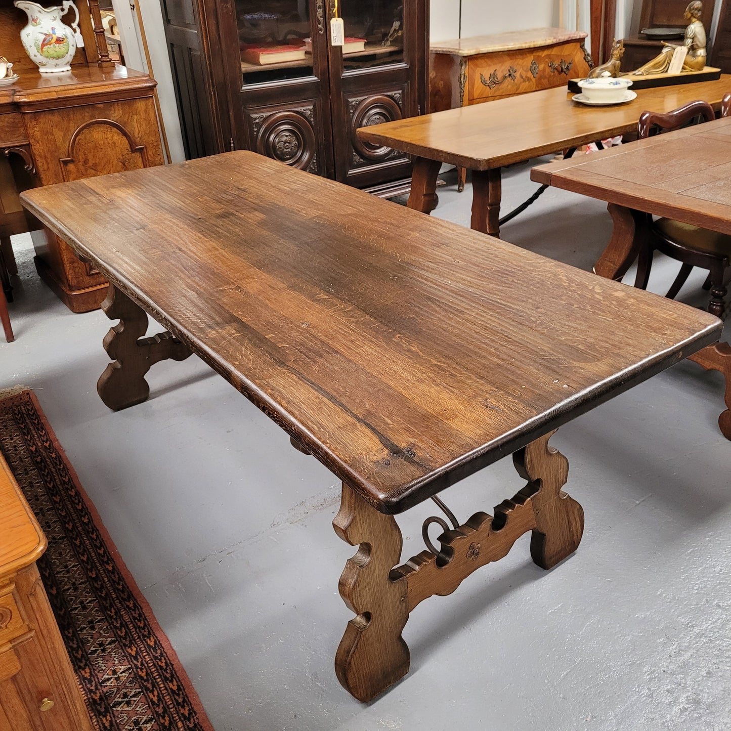 French Oak Spanish style farmhouse dining table with beautiful iron work underneath. It has been sourced from France and is in good original detailed condition.