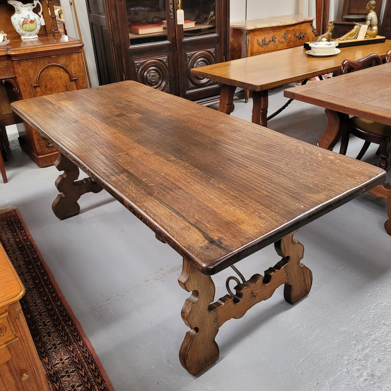 French Oak Spanish style farmhouse dining table with beautiful iron work underneath. It has been sourced from France and is in good original detailed condition.