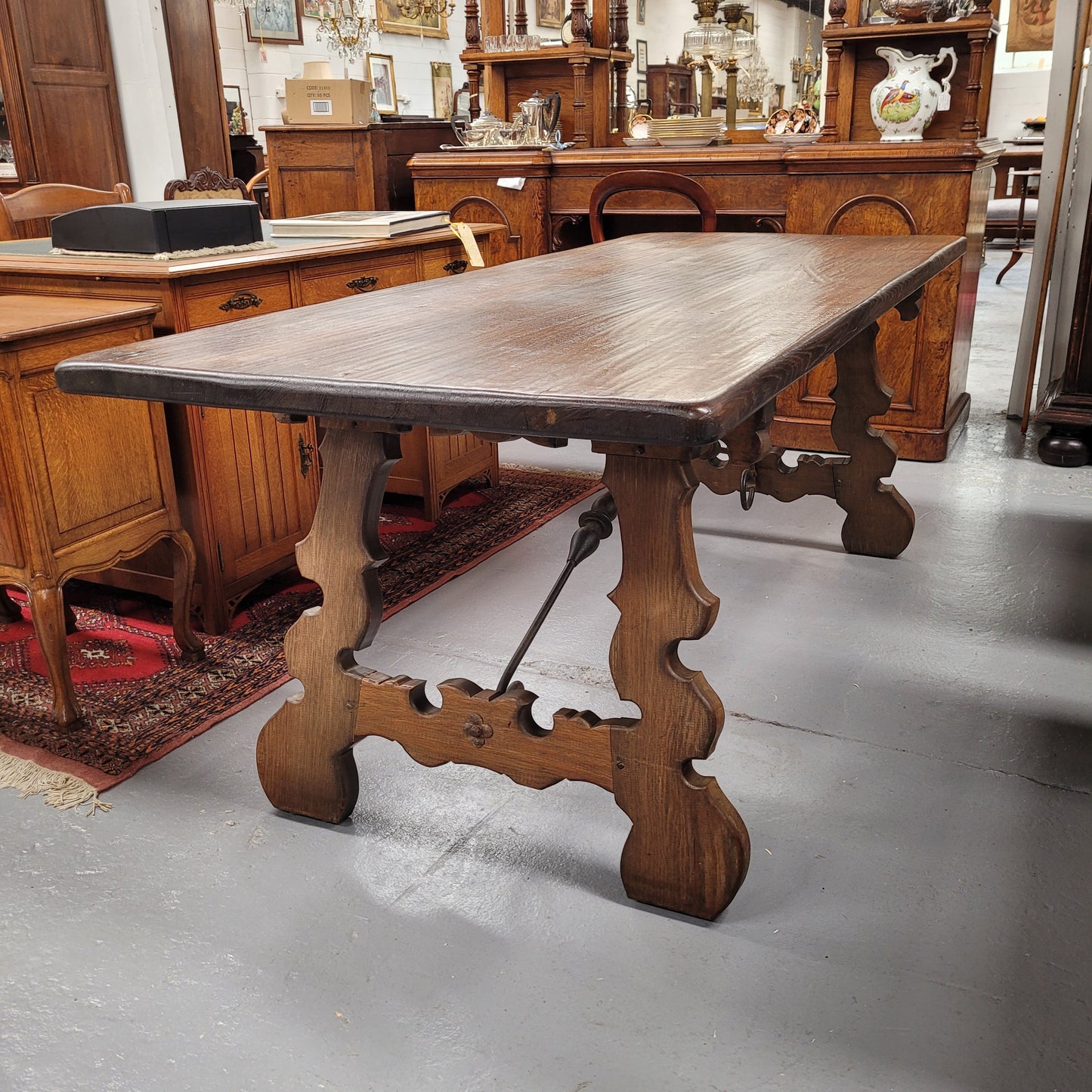 French Oak Spanish style farmhouse dining table with beautiful iron work underneath. It has been sourced from France and is in good original detailed condition.