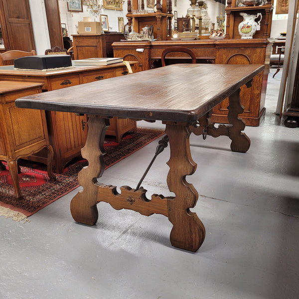 French Oak Spanish style farmhouse dining table with beautiful iron work underneath. It has been sourced from France and is in good original detailed condition.