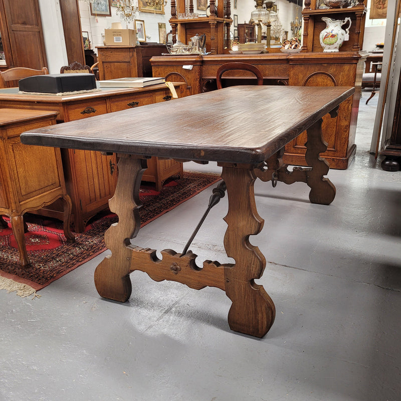 French Oak Spanish style farmhouse dining table with beautiful iron work underneath. It has been sourced from France and is in good original detailed condition.
