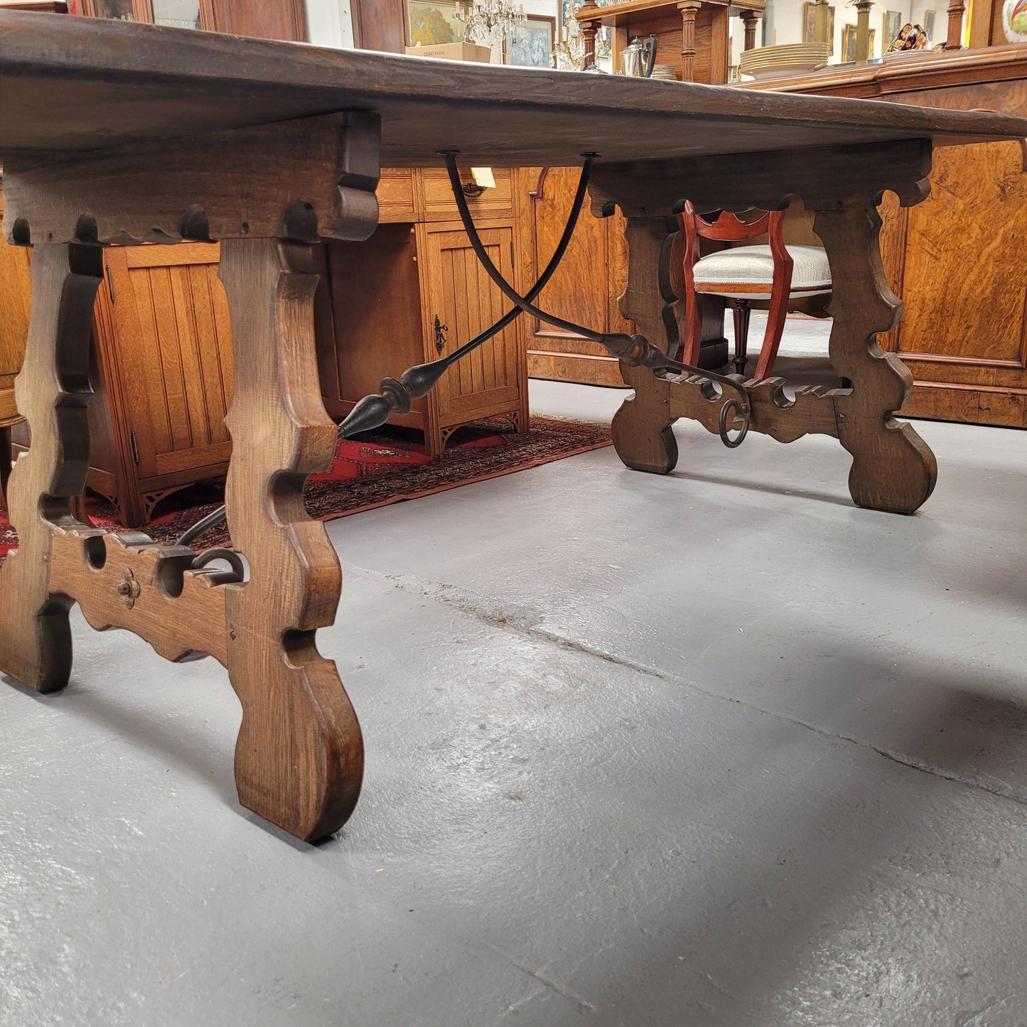 French Oak Spanish style farmhouse dining table with beautiful iron work underneath. It has been sourced from France and is in good original detailed condition.