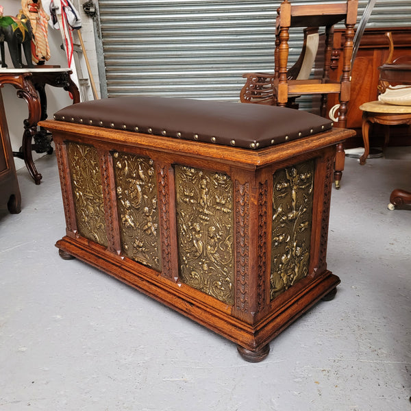 Antique French Oak coffer featuring decorative brass panels and a faux leather top. Brass panels are highly decorative featuring cherubs&nbsp; and faux leather in good used condition with very small signs of wear