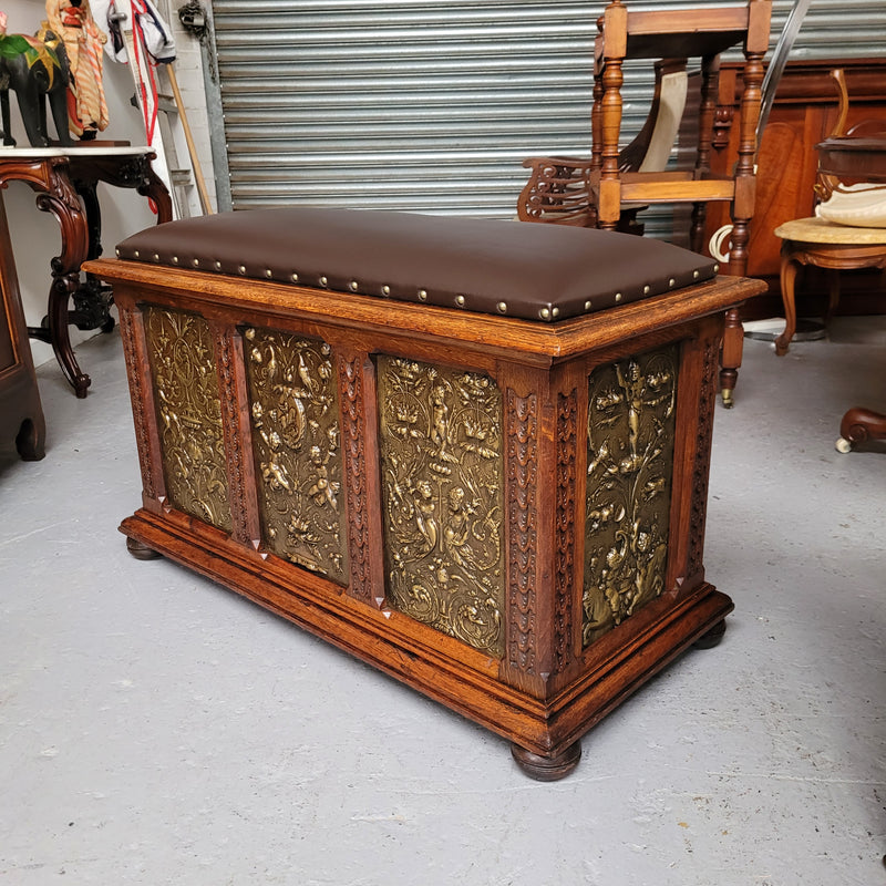 Antique French Oak coffer featuring decorative brass panels and a faux leather top. Brass panels are highly decorative featuring cherubs&nbsp; and faux leather in good used condition with very small signs of wear