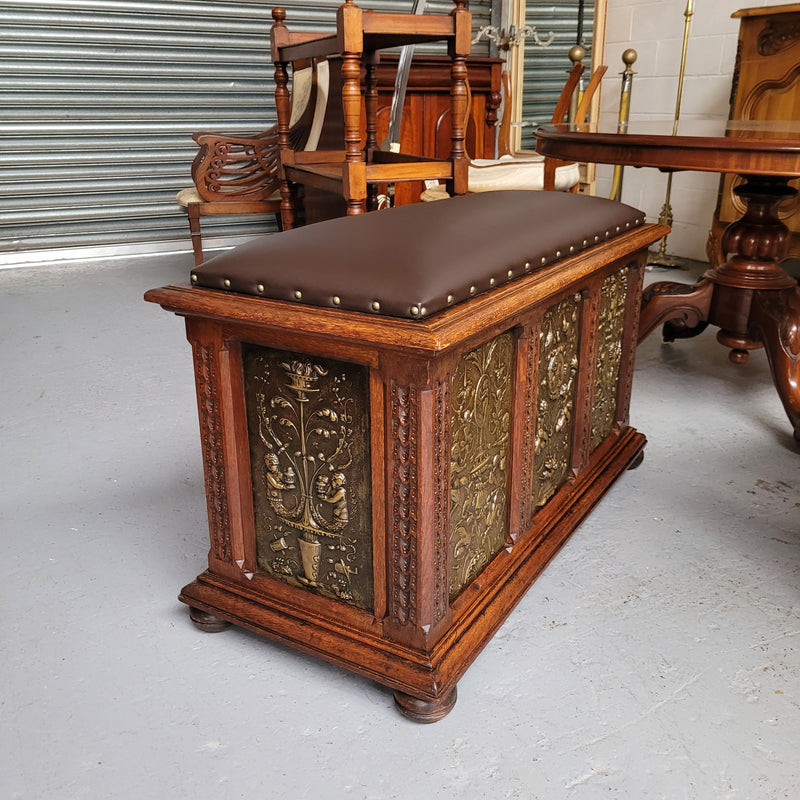 Antique French Oak coffer featuring decorative brass panels and a faux leather top. Brass panels are highly decorative featuring cherubs&nbsp; and faux leather in good used condition with very small signs of wear
