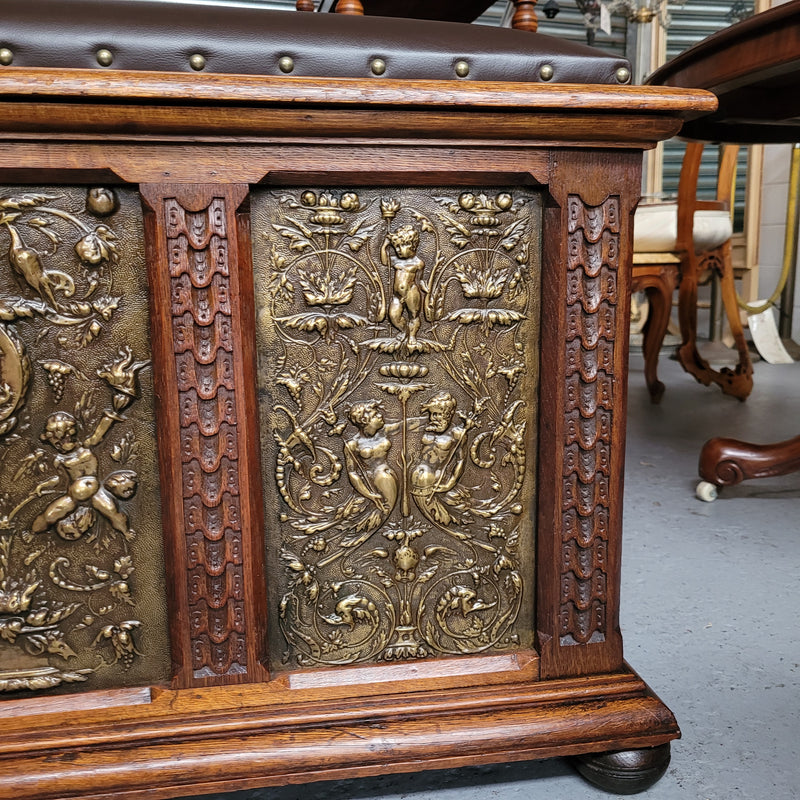 Antique French Oak coffer featuring decorative brass panels and a faux leather top. Brass panels are highly decorative featuring cherubs&nbsp; and faux leather in good used condition with very small signs of wear