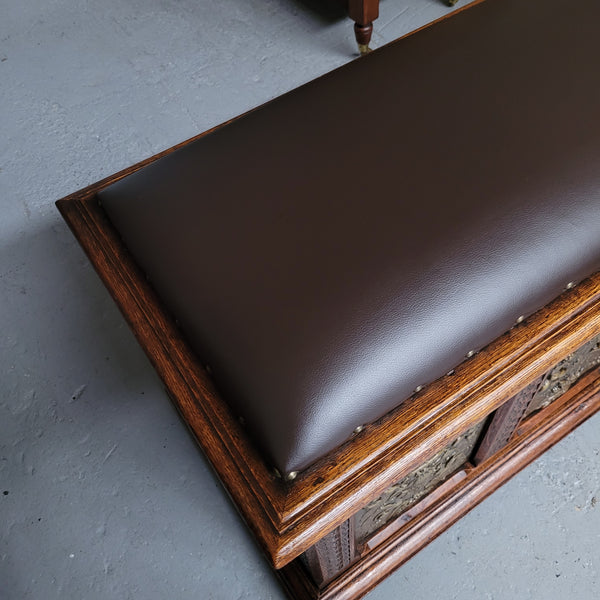 Antique French Oak coffer featuring decorative brass panels and a faux leather top. Brass panels are highly decorative featuring cherubs&nbsp; and faux leather in good used condition with very small signs of wear