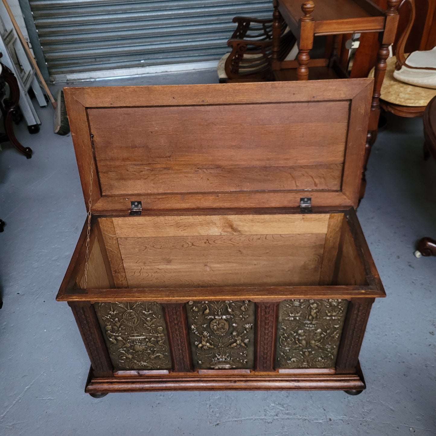 Antique French Oak coffer featuring decorative brass panels and a faux leather top. Brass panels are highly decorative featuring cherubs&nbsp; and faux leather in good used condition with very small signs of wear
