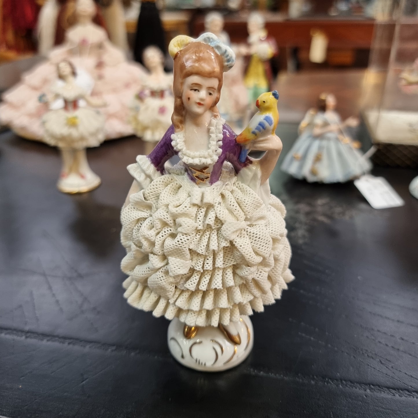 Dresden lace figurine stamped underneath and made in Germany. In good vintage condition with some slight damage to lace.