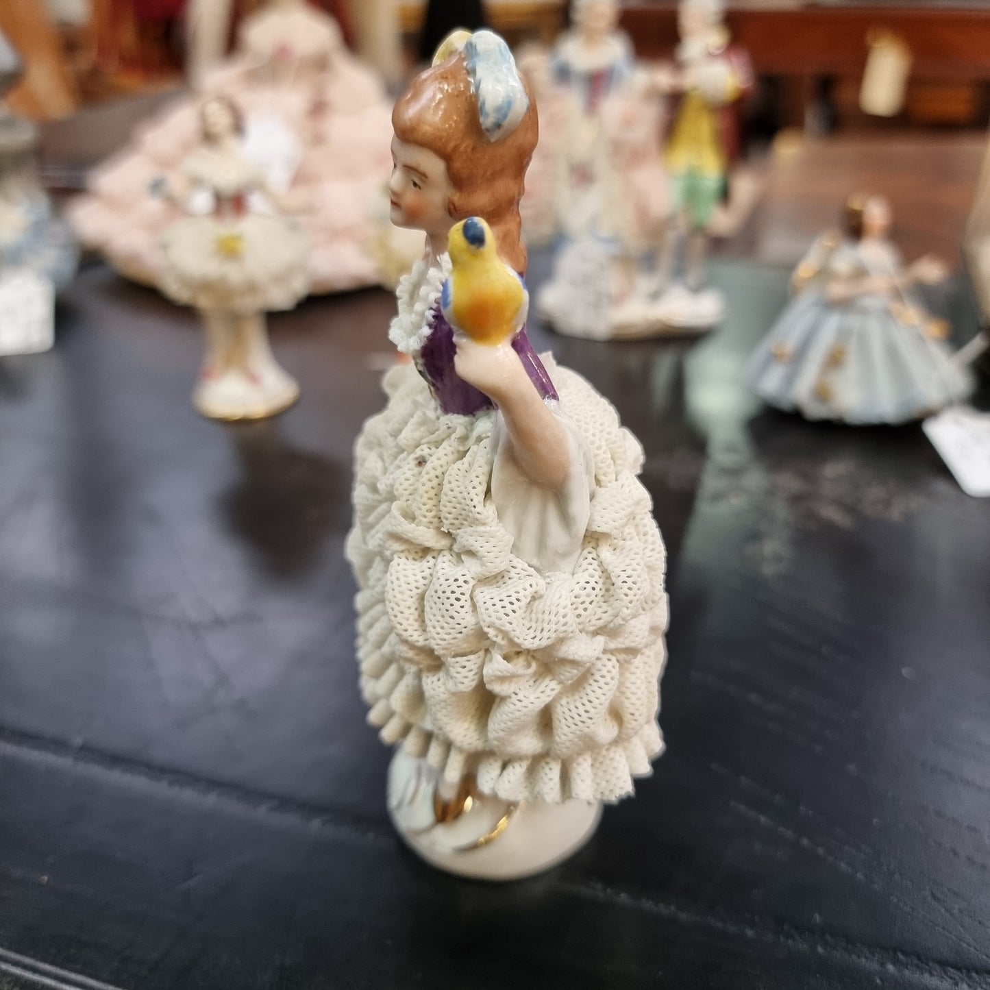 Dresden lace figurine stamped underneath and made in Germany. In good vintage condition with some slight damage to lace.