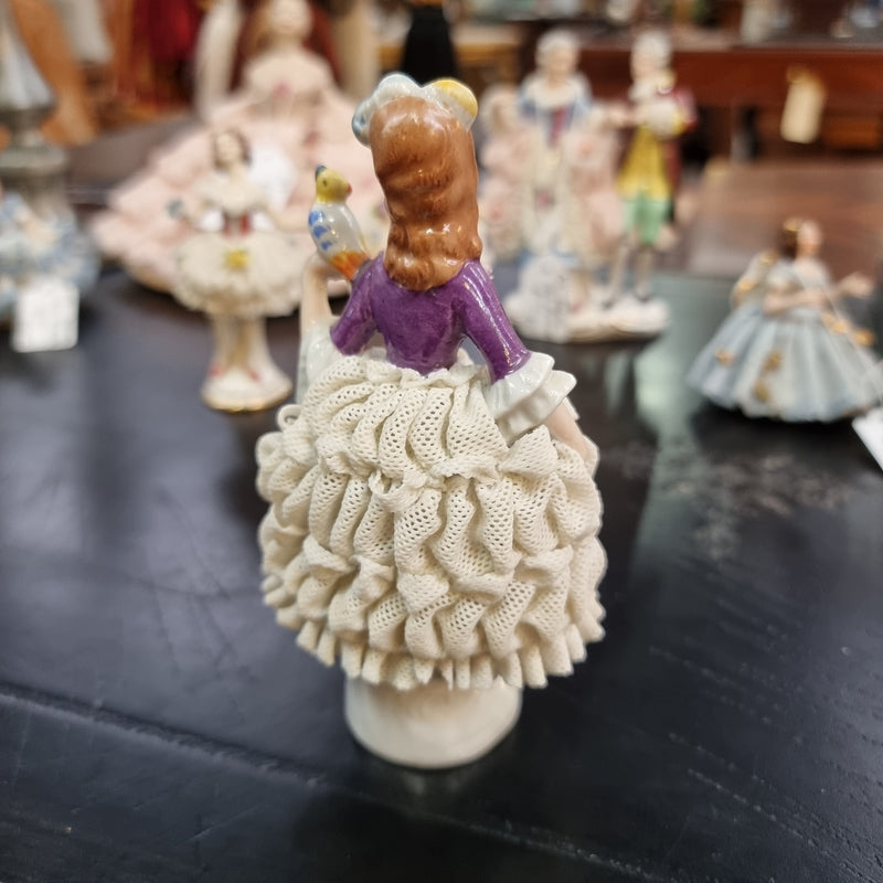 Dresden lace figurine stamped underneath and made in Germany. In good vintage condition with some slight damage to lace.