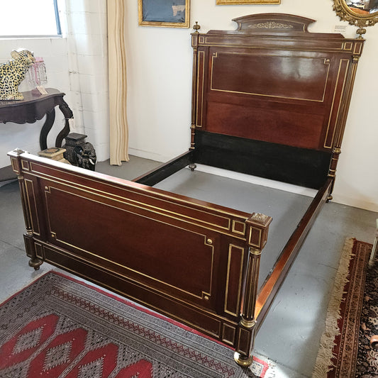 A stunning Empire French mahogany and brass inlaid queen size bed. It comes complete with side rails and custom made slats ready for your mattress. Sourced from France it is in good original detailed condition. Please view photos as they help to form part of the description and condition.