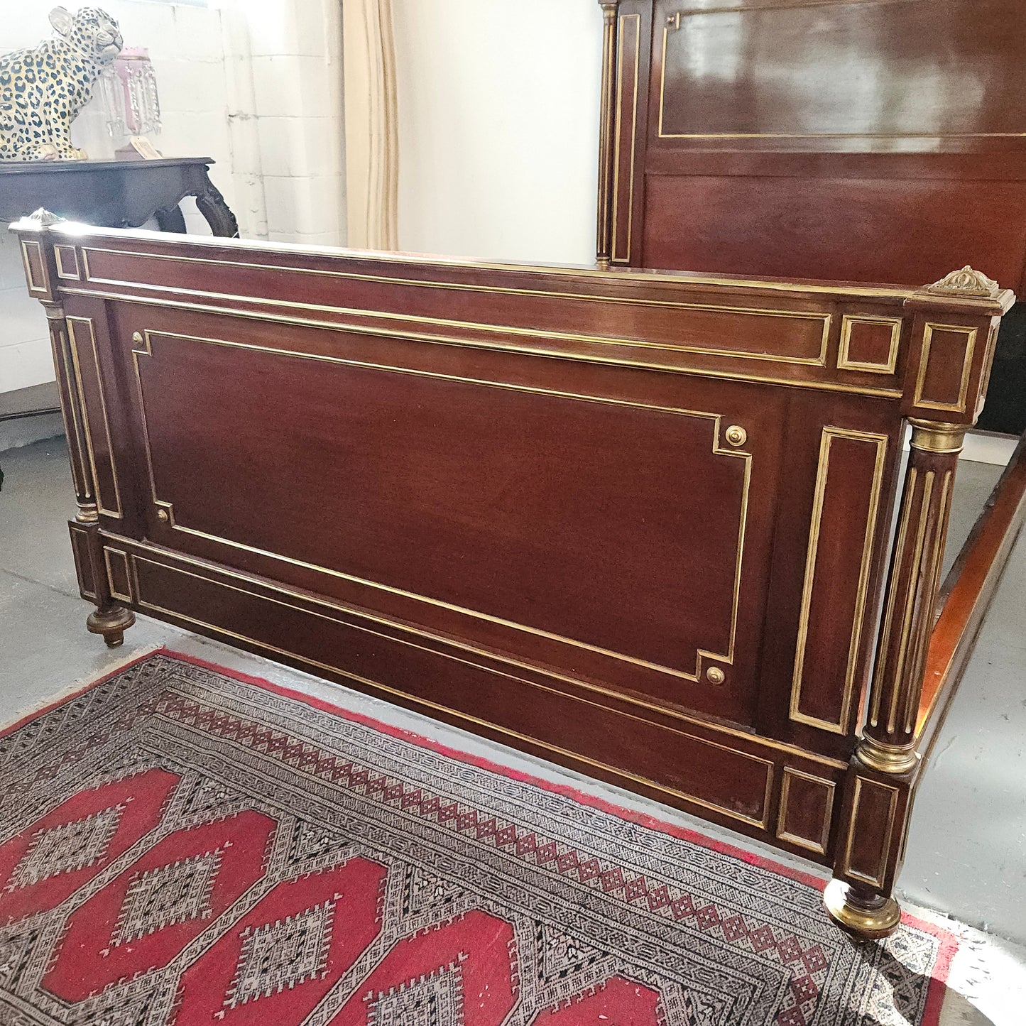 A stunning Empire French mahogany and brass inlaid queen size bed. It comes complete with side rails and custom made slats ready for your mattress. Sourced from France it is in good original detailed condition. Please view photos as they help to form part of the description and condition.