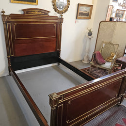 A stunning Empire French mahogany and brass inlaid queen size bed. It comes complete with side rails and custom made slats ready for your mattress. Sourced from France it is in good original detailed condition. Please view photos as they help to form part of the description and condition.