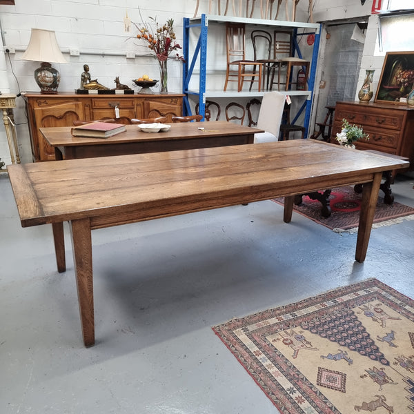 Vintage reclaimed French Oak farmhouse style dining table. It is 1 meter wide and 2.5 meters long this charming table comfortably seats 10. Made from thick Oak timber planks, It is in good original detailed condition. 