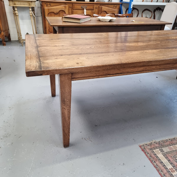 Vintage reclaimed French Oak farmhouse style dining table. It is 1 meter wide and 2.5 meters long this charming table comfortably seats 10. Made from thick Oak timber planks, It is in good original detailed condition. 