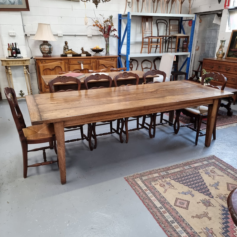 Vintage reclaimed French Oak farmhouse style dining table. It is 1 meter wide and 2.5 meters long this charming table comfortably seats 10. Made from thick Oak timber planks, It is in good original detailed condition. 