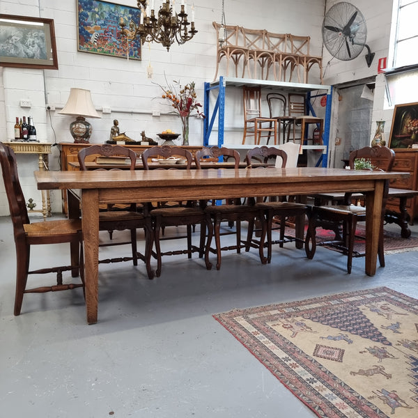 Vintage reclaimed French Oak farmhouse style dining table. It is 1 meter wide and 2.5 meters long this charming table comfortably seats 10. Made from thick Oak timber planks, It is in good original detailed condition. 