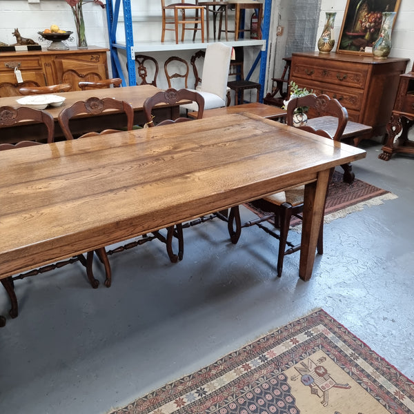 Vintage reclaimed French Oak farmhouse style dining table. It is 1 meter wide and 2.5 meters long this charming table comfortably seats 10. Made from thick Oak timber planks, It is in good original detailed condition. 