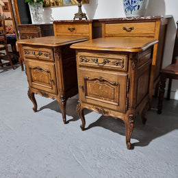 A Rare pair of Antique French Oak Louis XV style wooden top bedside cabinets. Featuring decorative carvings and classical Louis XV cabriole legs. These have been sourced directly from France and are in good original detailed condition.