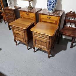 A Rare pair of Antique French Oak Louis XV style wooden top bedside cabinets. Featuring decorative carvings and classical Louis XV cabriole legs. These have been sourced directly from France and are in good original detailed condition.