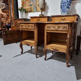 A Rare pair of Antique French Oak Louis XV style wooden top bedside cabinets. Featuring decorative carvings and classical Louis XV cabriole legs. These have been sourced directly from France and are in good original detailed condition.