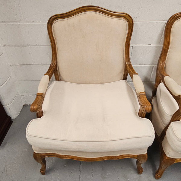 Pair of vintage Louis 15th style oak framed bergeres chairs with good size seats. making them very comfortable to sit in. The upholstery is in used condition with stains as shown in photos. Overall the timber frames are strong &amp; solid. They have been sourced directly from France. 