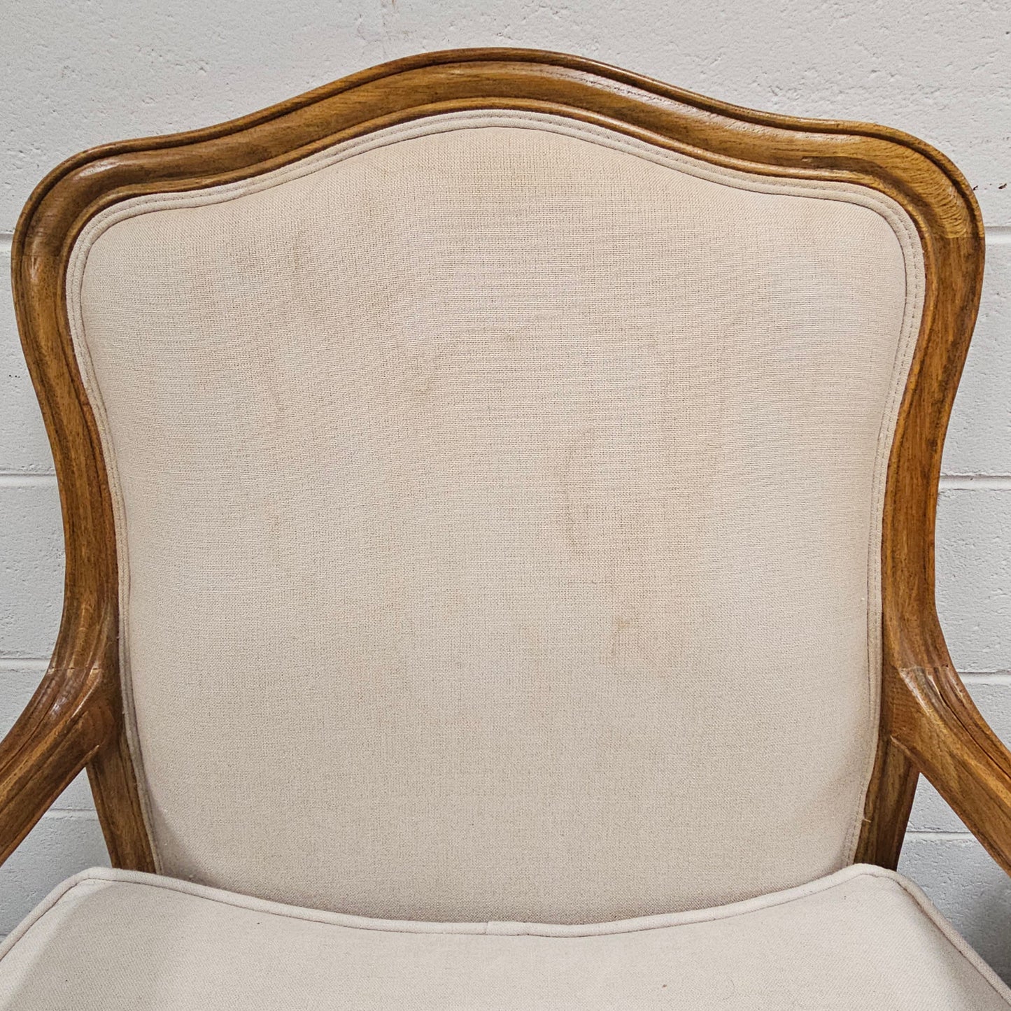 Pair of vintage Louis 15th style oak framed bergeres chairs with good size seats. making them very comfortable to sit in. The upholstery is in used condition with stains as shown in photos. Overall the timber frames are strong &amp; solid. They have been sourced directly from France. 